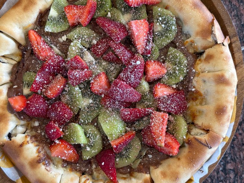 Nutella pizza dessert with fresh strawberries