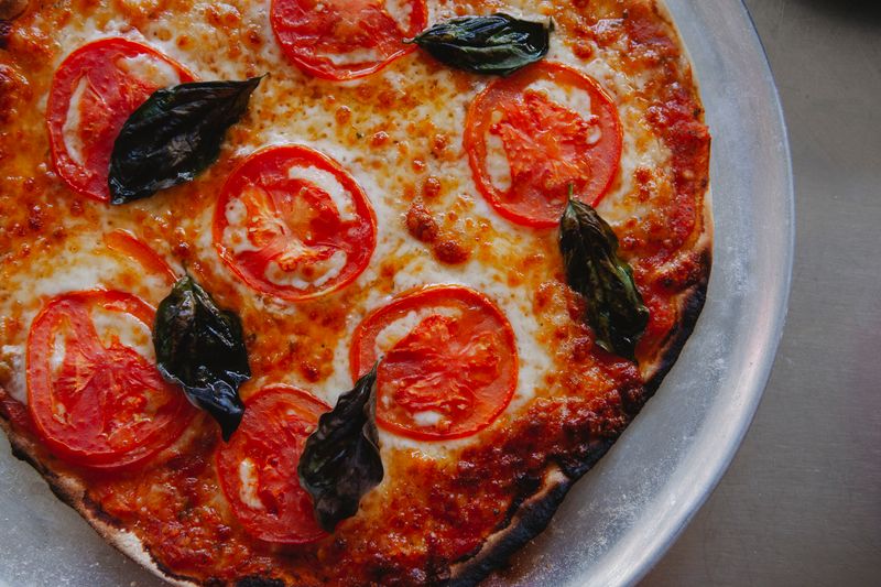 Punch Margherita pizza with San Marzano tomatoes and fresh mozzarella